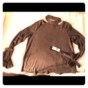 A. Burr choker neck sweater with buckle accent